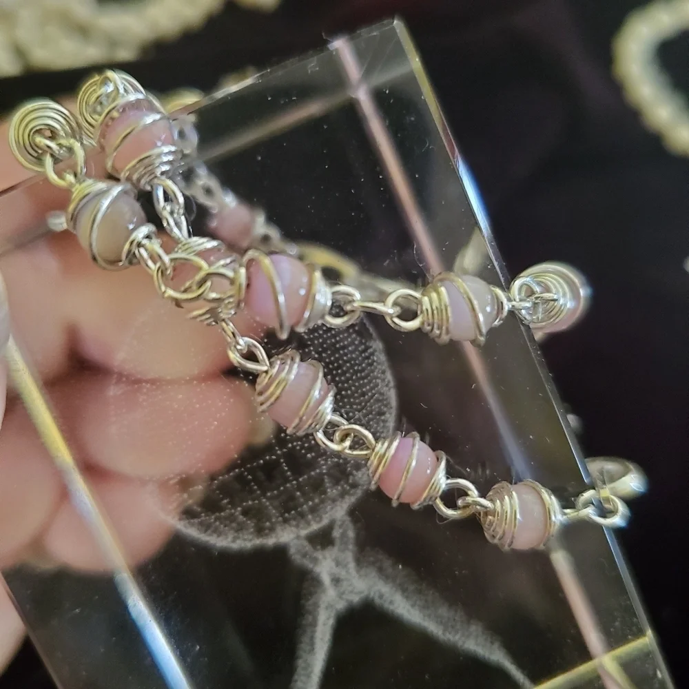 Two silver with pink pearl stones